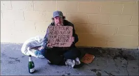  ??  ?? Russell Morisch, who goes by the street name “Shadow,” is one of thousands of homeless people in Seattle. Morisch often stakes out a corner where Amazon employees walk by and has a sign for them and other tech workers. Tech companies now fill many...