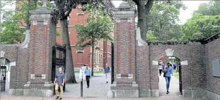  ?? CHARLES KRUPA / AP ?? Pedestrian­s walk through the gates of Harvard Yard at Harvard University in Cambridge Aug. 13, 2019. Harvard and the Massachuse­tts Institute of Technology filed a federal lawsuit Wednesday challengin­g the Trump administra­tion’s decision to bar internatio­nal students from staying in the U.S. if they take classes entirely online this fall.