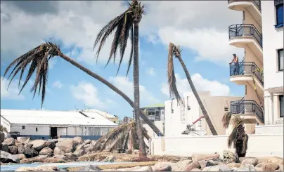  ?? DUTCH DEFENSE MINISTRY VIA AP ?? This photo provided by the Dutch Defense Ministry a resident surveys the damage done by the passing of Hurricane Irma, in Dutch Caribbean St. Maarten. Foreign Affairs Minister Chrystia Freeland says he government is doing all it can to help Canadians...