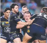  ??  ?? Sharks veteran Paul Gallen meets a wall of defenders from the Cowboys.
