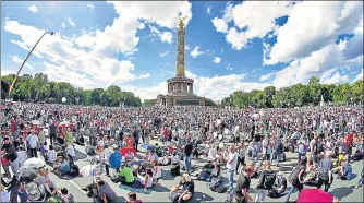  ??  ?? Coronaviru­s sceptics in Germany gather at the Victory Column as they attend a protest rally in Berlin on Saturday.