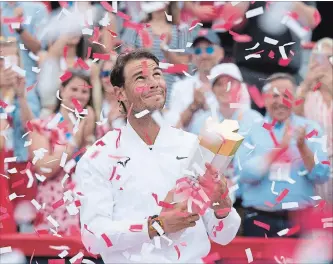  ?? PAUL CHIASSON THE CANADIAN PRESS ?? Rafael Nadal, of Spain, holds up the trophy after beating Daniil Medvedev, of Russia, in the final at the Rogers Cup tennis tournament, in Montreal on Sunday.