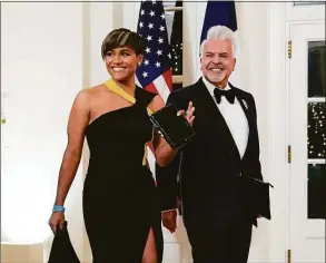  ?? Susan Walsh / Associated Press ?? Actor Ariana DeBose and Henry Munoz III arrive for the State Dinner with President Joe Biden and French President Emmanuel Macron at the White House on Dec. 1.