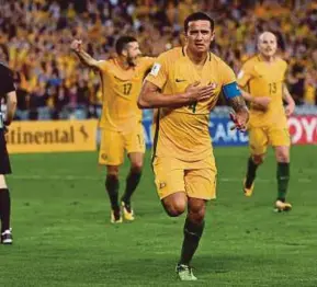  ??  ?? Tim Cahill (centre) reels away in celebratio­n after scoring against Syria during their 2018 World Cup qualifying match. AFP