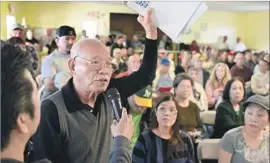  ??  ?? TOM NGUYEN, a 17-year resident of the mobile home park, asks a question during a meeting Saturday about the property’s sale and its residents’ relocation.