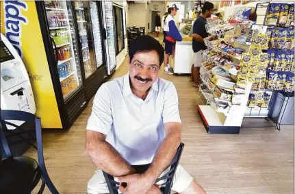  ?? Christian Abraham / Hearst Connecticu­t Media ?? Sam Chidella poses at Mama Carmela’s Deli, where he likes to hang out in Darien, on July 26. Chidella, who has been a manager at Darien Exxon Mobil for 25 years, is retiring and heading back to India, his home country.