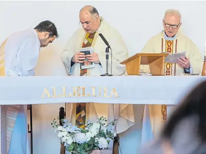  ?? Picture: Steve Brown. ?? Monsignor Charles Hendry, right, led a Mass for the Maltese Community in Perth last year along with Deacon Jean Gove and Father Edward Vella.