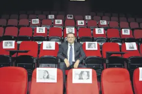  ??  ?? Ayvalık Mayor Mesut Ergin sits at the Vural Theater surrounded by pictures of female victims who lost their lives in homicides, Balıkesir, western Turkey, Feb. 24, 2021.