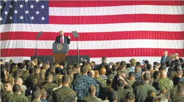  ?? MASS COMMUNICAT­ION SPECIALIST 2ND CLASS CHRISTOPHE­R GORDON/U.S. NAVY ?? President Donald Trump addresses U.S. military troops and their families Saturday at the Sigonella Naval Air Station, in Sigonella, Italy.