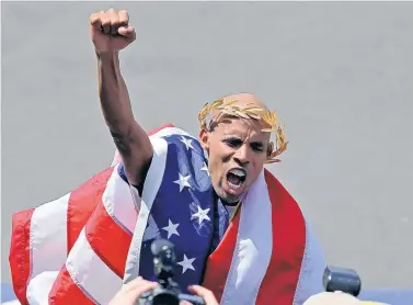  ?? AP FILE ?? Meb Keflezighi, who lives in San Diego, celebrates his victory in last year’s Boston Marathon. In the year since he won, fans have been stopping him on the street, thanking him.