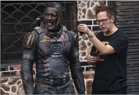  ?? WARNER BROS. PICTURES ?? Writer-director James Gunn works with actor Idris Elba on location for “The Suicide Squad.”