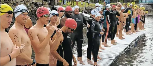  ??  ?? ON YOUR MARKS: About 50 people jumped in from the Halyards Hotel jetty for a short swim to a wet start at the Royal Alfred Marina canal in warm weather in a previous Amanzi Challenge event in Port Alfred