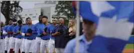  ?? WILFREDO LEE — THE ASSOCIATED PRESS ?? Players and coaches with the Cuban Profession­al Baseball Federation sing the Cuban national anthem before an exhibition baseball game against Miami Dade College.