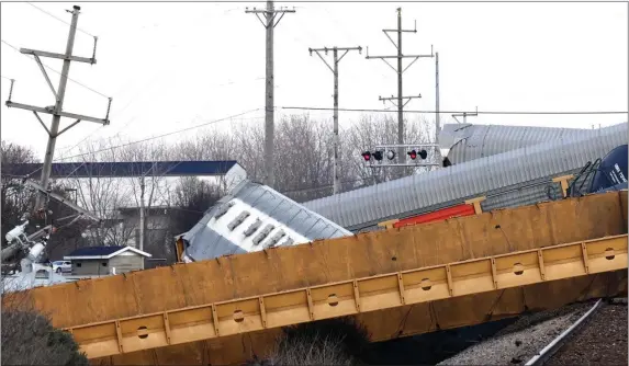  ?? BILL LACKEY — SPRINGFIEL­D-NEWS SUN VIA AP ?? Multiple cars of a Norfolk Southern train lie toppled on one another after derailing at a train crossing with Ohio 41 in Clark County, Ohio, Saturday, March 4, 2023.