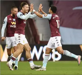  ??  ?? Jack Grealish celebrates with Trezeguet (right) after his goal