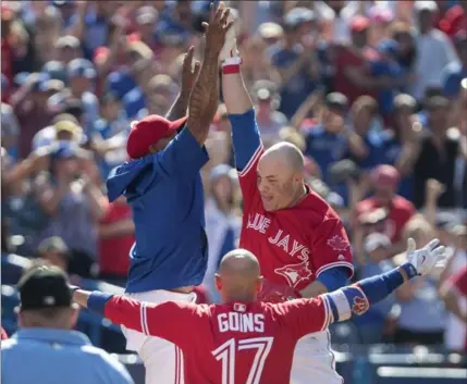  ?? FRED THORNHILL, THE CANADIAN PRESS ?? Steve Pearce, right, high-fives Marcus Stroman after his walkoff grand slam Sunday. The Jays trailed 10-4 going into the bottom of the ninth.