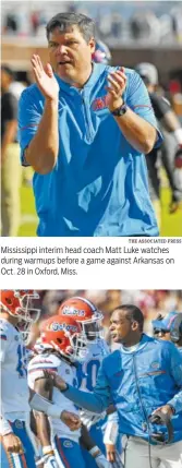  ?? THE ASSOCIATED PRESS THE ASSOCIATED PRESS ?? Mississipp­i interim head coach Matt Luke watches during warmups before a game against Arkansas on Oct. 28 in Oxford, Miss. Florida interim head coach Randy Shannon talks with quarterbac­k Feleipe Franks, left, during the first half against South...