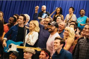  ?? PETER FISHER — THE NEW YORK TIMES ?? Huey Lewis, center with his fist in the air, with the cast of “The Heart of Rock and Roll.”