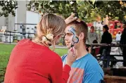  ?? [PHOTOS PROVIDED] ?? A recent Cleveland County celebratio­n included face painting, as well as food and other activities.