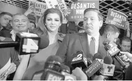  ?? PHELAN M. EBENHACK/AP ?? In this Nov. 6, 2018, file photo, Ron DeSantis answers questions from reporters, with his wife Casey, after being declared the winner of the Florida gubernator­ial race at an election party. Standing behind Casey DeSantis is Lev Parnas, who is facing federal campaign finance charges.