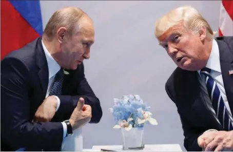  ??  ?? Russian President Vladimir Putin (left) talks with U.S. President Donald Trump at the G-20 Summit in Hamburg, Germany, last year. Photo credit: Associated Press