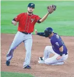  ?? ADOLPHE PIERRE-LOUIS/
JOURNAL ?? Trevor Story, right, of the Isotopes,
reaches base ahead
of the tag of El Paso’s Diego Goris
on Sunday night at Isotopes Park.