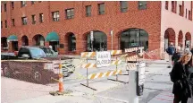  ?? [PHOTO BY DOUG HOKE, THE OKLAHOMAN] ?? Access to The Urban Taco Shop and Sweets & Eats has been closed. Robinson Avenue remains closed while crews inspect the First National Center for more problems and repairs.