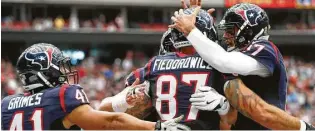  ?? Brett Coomer / Houston Chronicle ?? C.J. Fiedorowic­z (87) celebra junto al quarterbac­k Brock Osweiler (17) el touchdown que anotó en el triunfo sobre Detroit Lions.