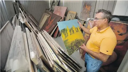  ?? ALLEN MCINNIS ?? Charles Leibovitch knows he faces a challenge in restoring his father’s many canvases, but he is optimistic that it can be done.