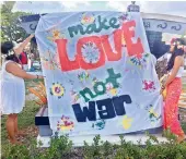  ??  ?? Guam residents hold a rally for peace in Hagatna, Guam on Monday. AP