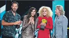  ?? Jason Kempin Getty Images ?? MEMBERS OF Little Big Town accept an award Wednesday in Nashville at the CMT Music Awards, where they also performed “Summer Fever” and hosted.