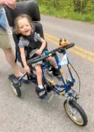  ?? CONTRIBUTE­D PHOTO BY JAYDENE LOWE ?? Jake Phipps takes a ride in his new adaptive tricycle built by Freedom Concepts.