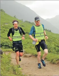  ??  ?? King of the Mountain winners Stu Wallker and Jon Morgan make their way back down Ben Nevis after Storm Hector disrupted the last leg of the race.