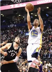  ??  ?? Golden State Warriors’ Stephen Curry scores against Toronto Raptors in their game in Toronto.