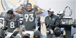  ?? JOHN RAOUX/AP ?? Baltimore Ravens quarterbac­k Lamar Jackson (8) and Jacksonvil­le Jaguars defensive end Calais Campbell (93), pictured with Pro Football Hall of Famers Bruce Smith and Terrell Davis (with trophy), were named most valuable players of the NFL Pro Bowl on Sunday of Camping World Stadium.