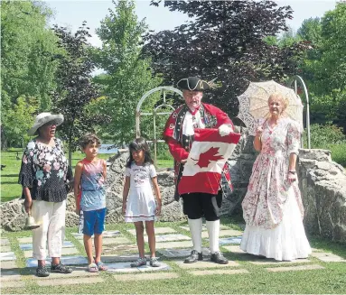  ?? COURTESY OF DOROTHY ABBOTT ?? Town Crier Bruce Kruger opens the 2019 Owen Sound Emancipati­on Day Festival at the Black History Cairn, with Sen. Wanda Thomas Bernard, far left, who wants Emancipati­on Day commemorat­ed in every town and city across Canada.