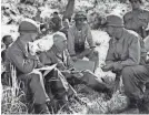  ?? AP FILE PHOTO ?? Maj. Gen. William Kean (no helmet) confers with his men in South Korea on Aug. 17, 1950.