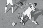  ?? [PHOTO BY BRYAN TERRY, THE OKLAHOMAN] ?? Kevon Lambert of Phoenix Rising FC fights off Energy FC’s Jose Barril during a USL soccer game Wednesday night at Taft Stadium.