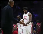  ?? ?? Philadelph­ia 76ers’ Joel Embiid (21) and James Harden (1) walk off the court during a timeout in the second half of an NBA basketball game against the Chicago Bulls, Monday in Philadelph­ia.
