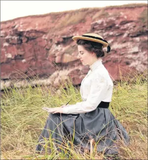  ?? SUBMITTED PHOTO ?? Meghan Greeley as Lucy Maud Montgomery sits atop a P.E.I. red sandstone cliff during the filming of the newest Heritage Minute. The Heritage Minute explores Montgomery’s struggle with mental illness and social convention­s while she faces early...
