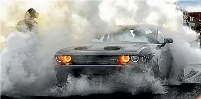  ??  ?? A Dodge Challenger celebrates claiming the top spot for the first time in the survey’s 34-year history.