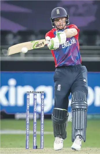  ?? Reuters ?? Jos Buttler hits a boundary on his way to an unbeaten 32-ball knock of 71 runs after England restricted Australia to just 125 at the Dubai Internatio­nal Stadium yesterday