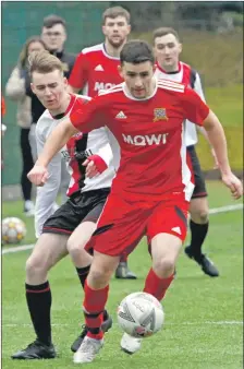  ?? ?? Right: Sean Noble heads for the Giffnock goal.