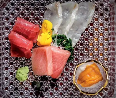  ??  ?? WHETTING THE APPETITE To prepare patrons for the main course, the restaurant serves two appetisers to get the meal going, like this sashimi platter from Taka by Sushi Saito