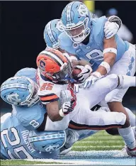  ?? Robert Willett / TNS ?? Syracuse running back Jawhar Jordan is stopped in the fourth quarter by North Carolina’s Kaimon Rucker (25), Khadry Jackson (8) and Cam'Ron Kelly (9) on Saturday in Chapel Hill, N.C. North Carolina won, 31-6.