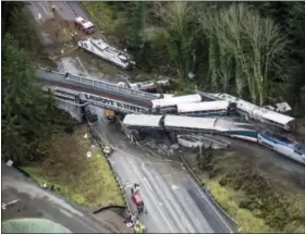  ?? BETTINA HANSEN — THE SEATTLE TIMES VIA AP ?? Cars from an Amtrak train that derailed lie spilled onto Interstate 5, Monday in DuPont, Wash.