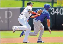  ?? JIM THOMPSON/JOURNAL ?? Isotope Cristhian Adames makes the tag on Iowa’s Mark Zagunis during a rundown in Tuesday’s game at Isotopes Park.