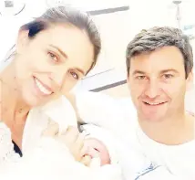  ??  ?? This handout photo taken from the Instagram account of Jacinda (left) shows her with partner Gayford (right) posing with their newborn baby girl, born at Auckland City Hospital. — AFP photo