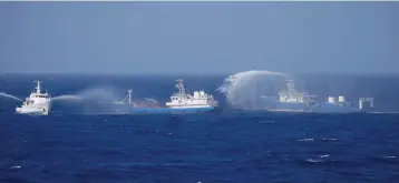  ?? (Reuters) ?? CHINESE SHIPS are seen during a search and rescue exercise near the Qilian Yu subgroup in the Paracel Islands, which is known in China as Xisha Islands, in the South China Sea, last month.