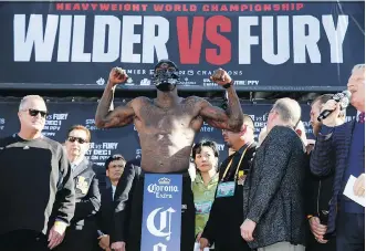  ?? PHOTOS: DAMIAN DOVARGANES/THE ASSOCIATED PRESS ?? WBC heavyweigh­t champ Deontay Wilder dons a mask during the official weigh-in ceremony Friday at Staples Center in Los Angeles, ahead of his bout against Tyson Fury.